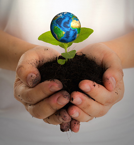 Hands with earth (Elements of this image furnished by NASA)